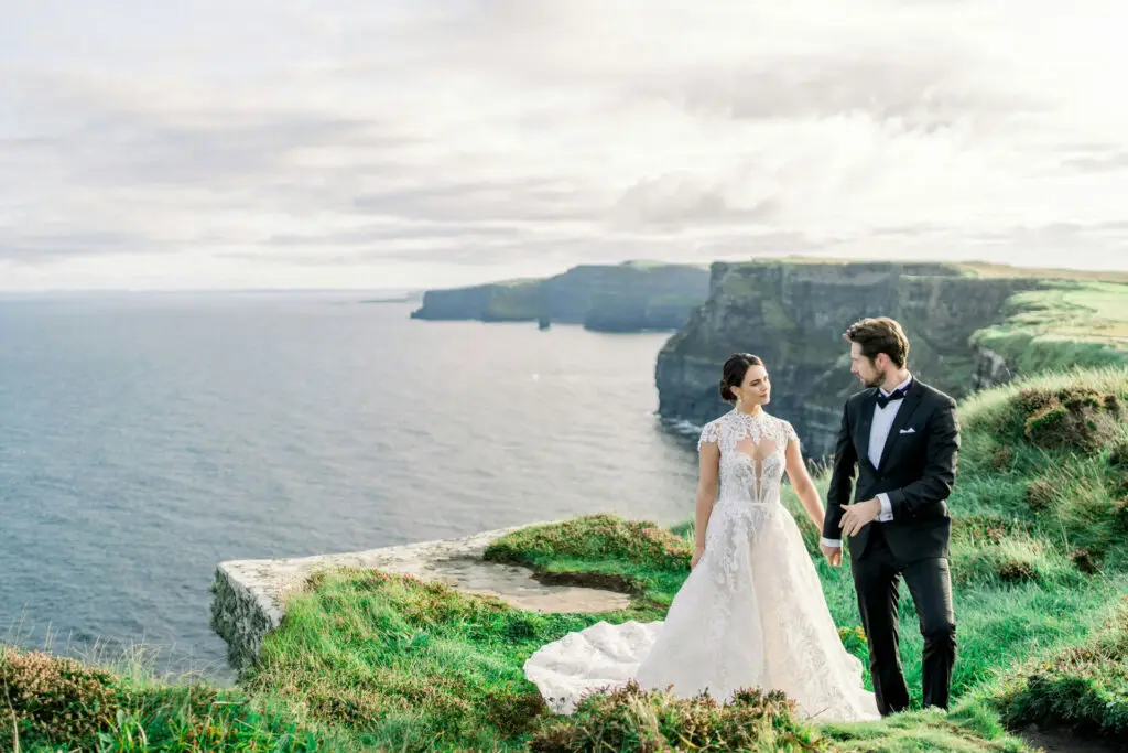 A bride & groom looking over the Cliffs of Moher, in County Clare, Ireland